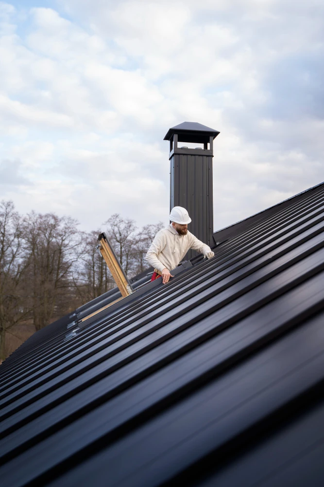 Specialist checking a chimney during residential roof cleaning and maintenance.