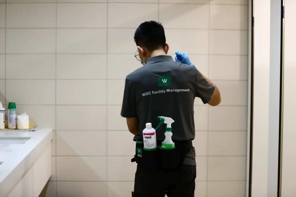 Commercial cleaner equipped with a backpack vacuum ready for office maintenance.