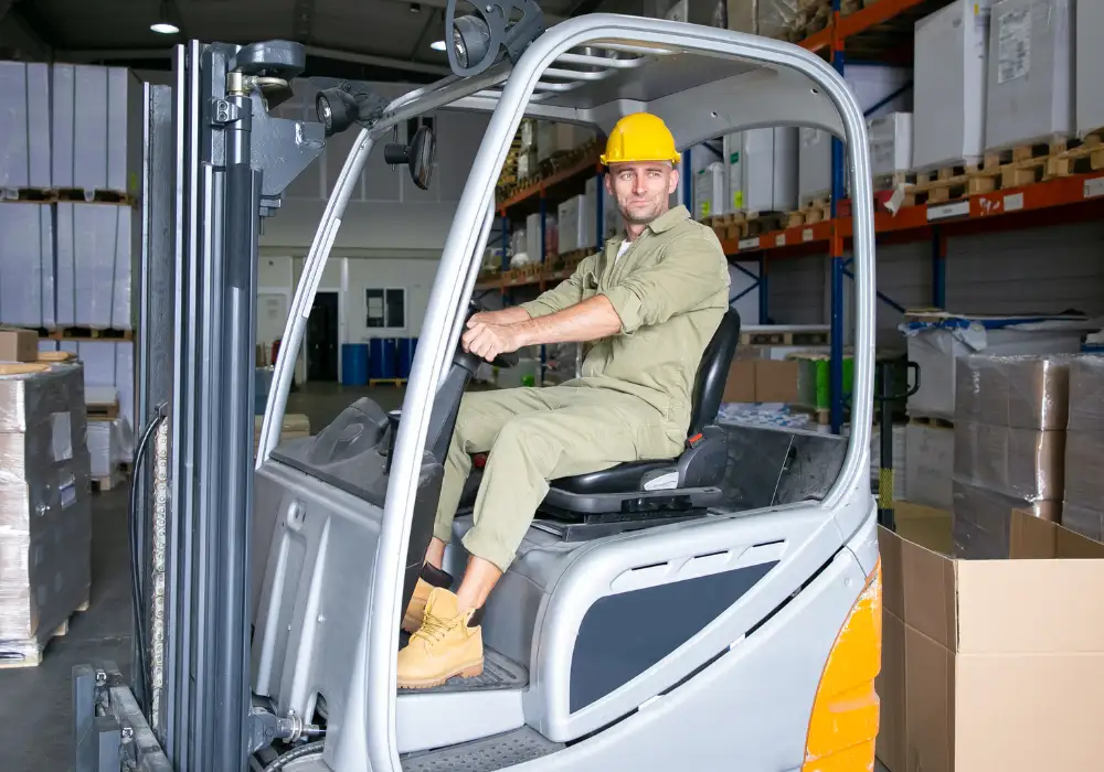 Forklift operator moving goods in a clean and well-maintained logistics warehouse.