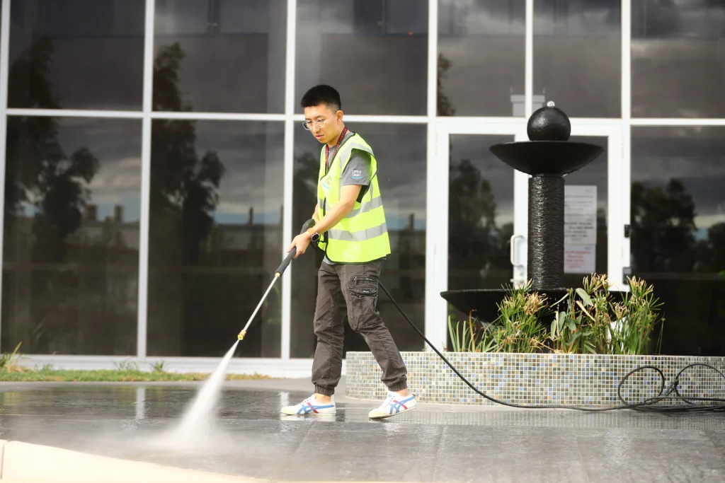 High-pressure cleaning of outdoor pavement to remove grime and stains.
