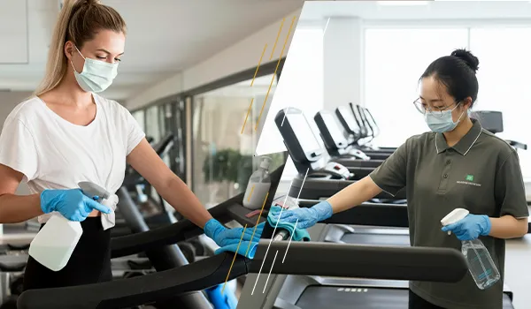 Commercial cleaner carefully wiping a large gym mirror to ensure a streak-free finish.