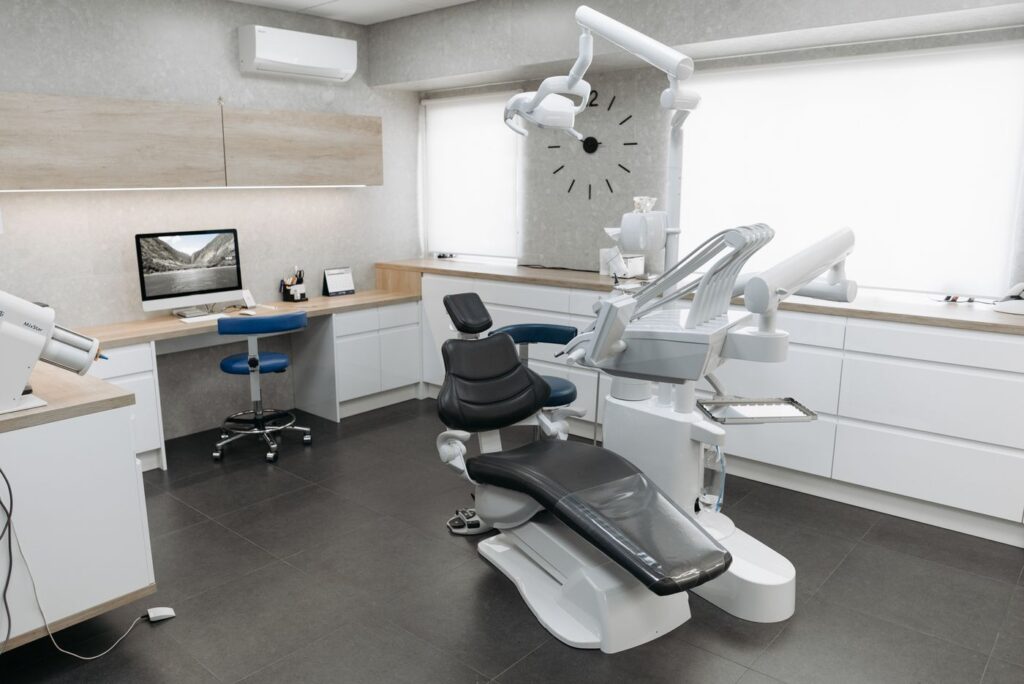 Dental treatment room with chair, washable floor and work surfaces