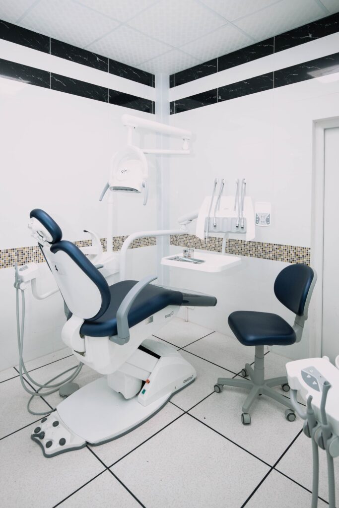 Dental chair and surrounding tiled floor in a treatment room
